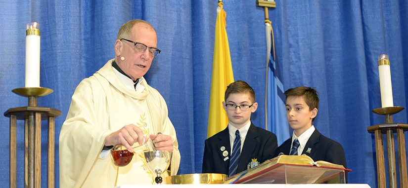 Father May Prepares Holy Communion at St. Michael's College School