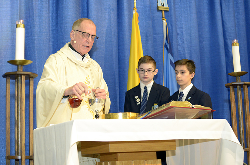 Father May Prepares Holy Communion at St. Michael's College School