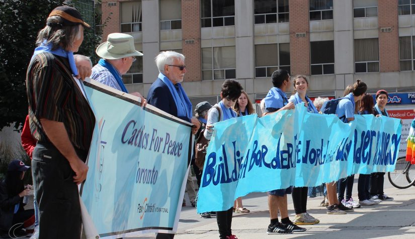 Participants hold up banner in