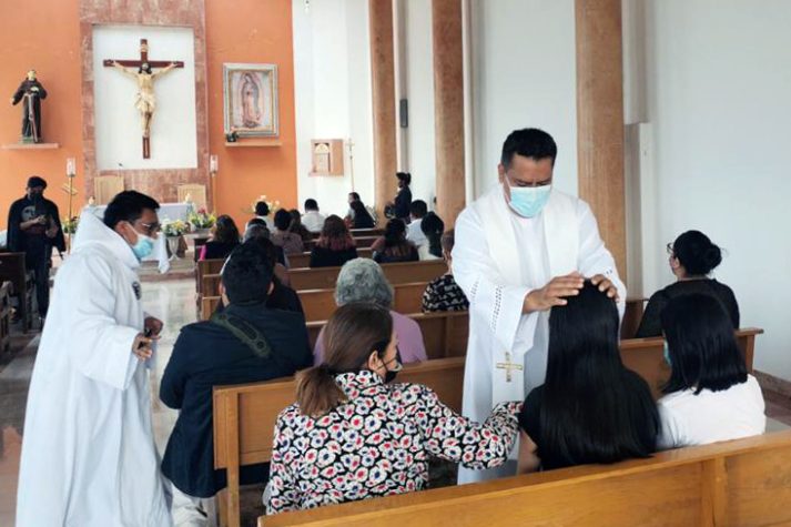 Father José Alberto blessing a parishioner.